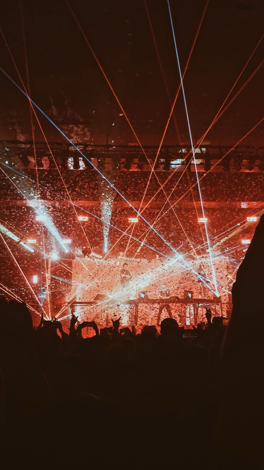 White light beams sweeping over a crowd at a concert