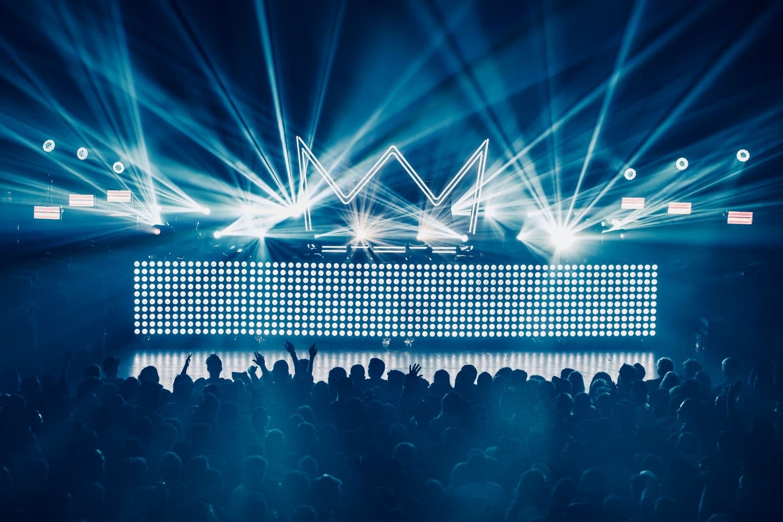 Dancers in silhouette against a lit stage in a club